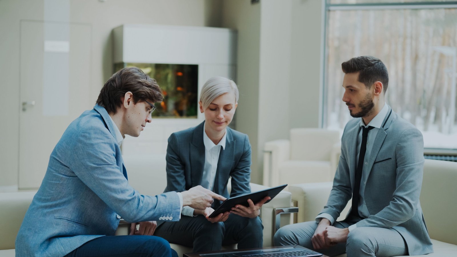 Three risk and security professionals reviewing findings together, representing Impradel's vetted network model
