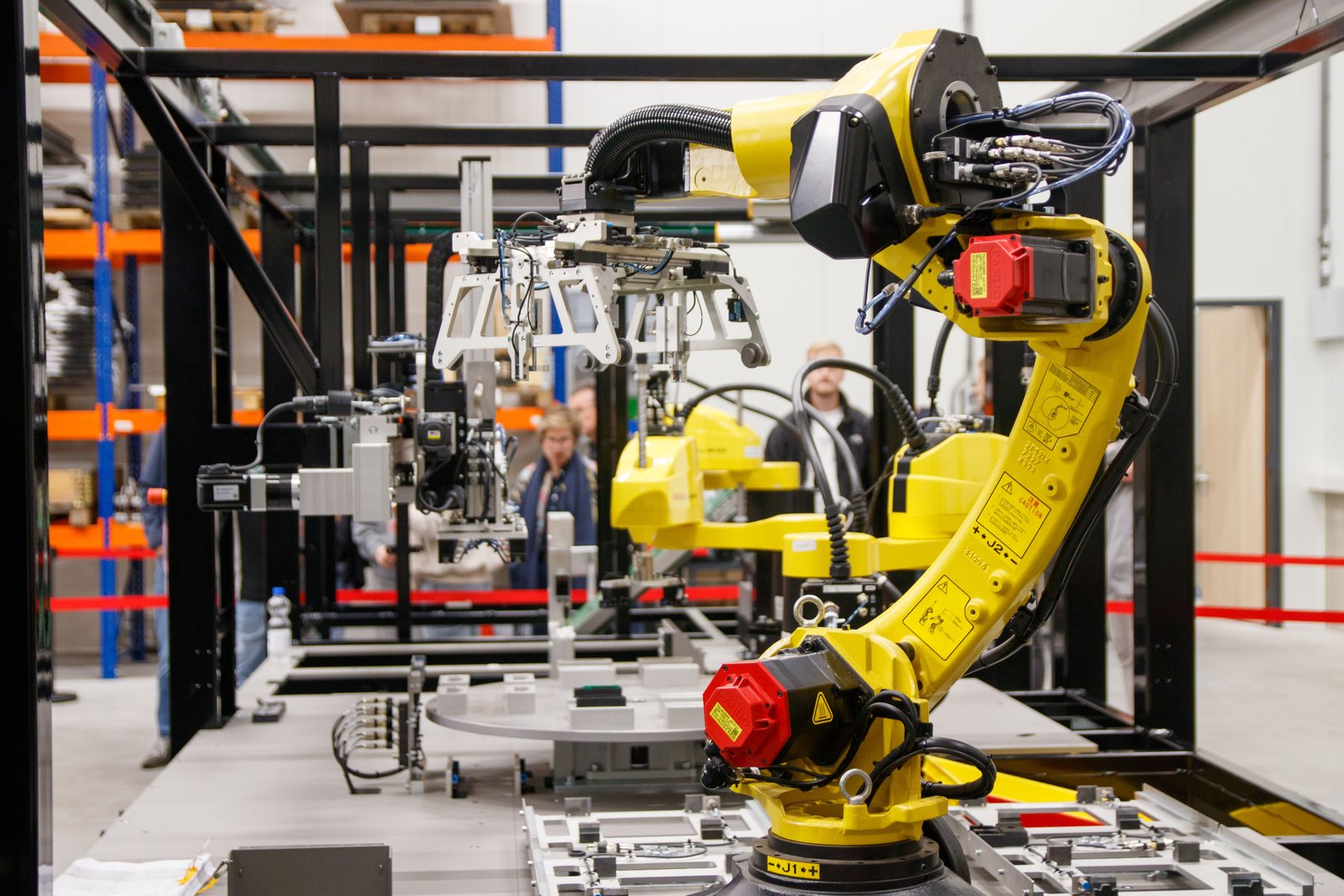 Industrial robotic arm on a modern manufacturing assembly line representing enterprise and corporate operations