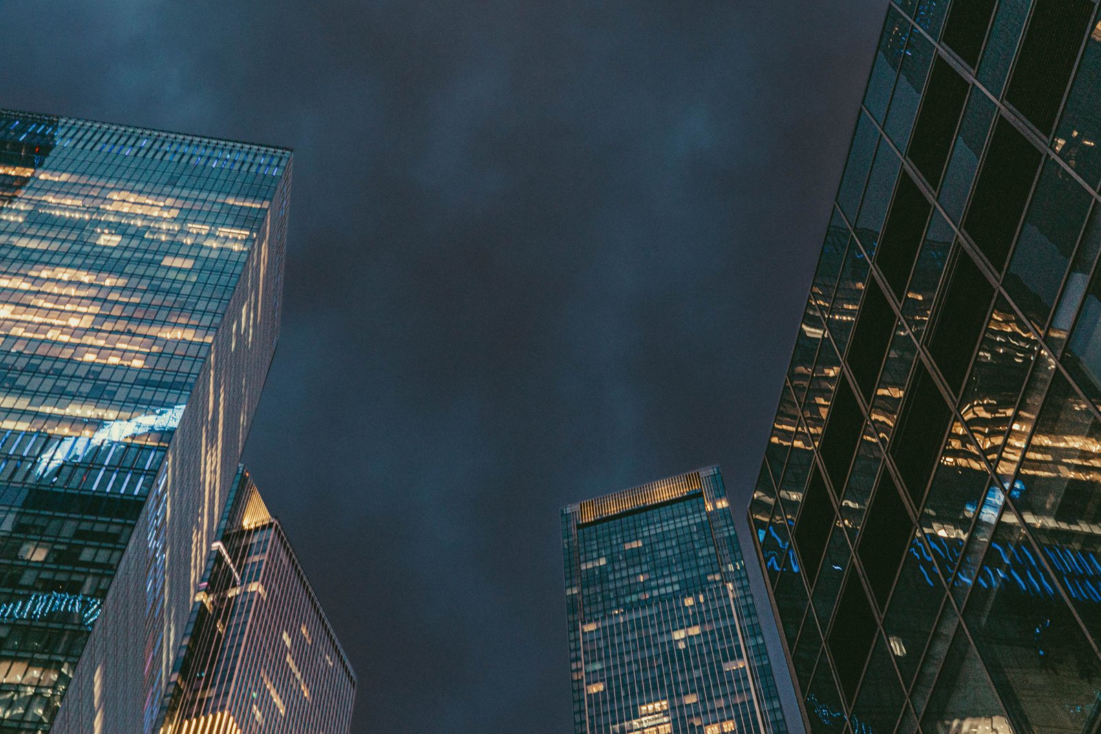 Modern financial district skyline at night representing the regulated industries Impradel serves