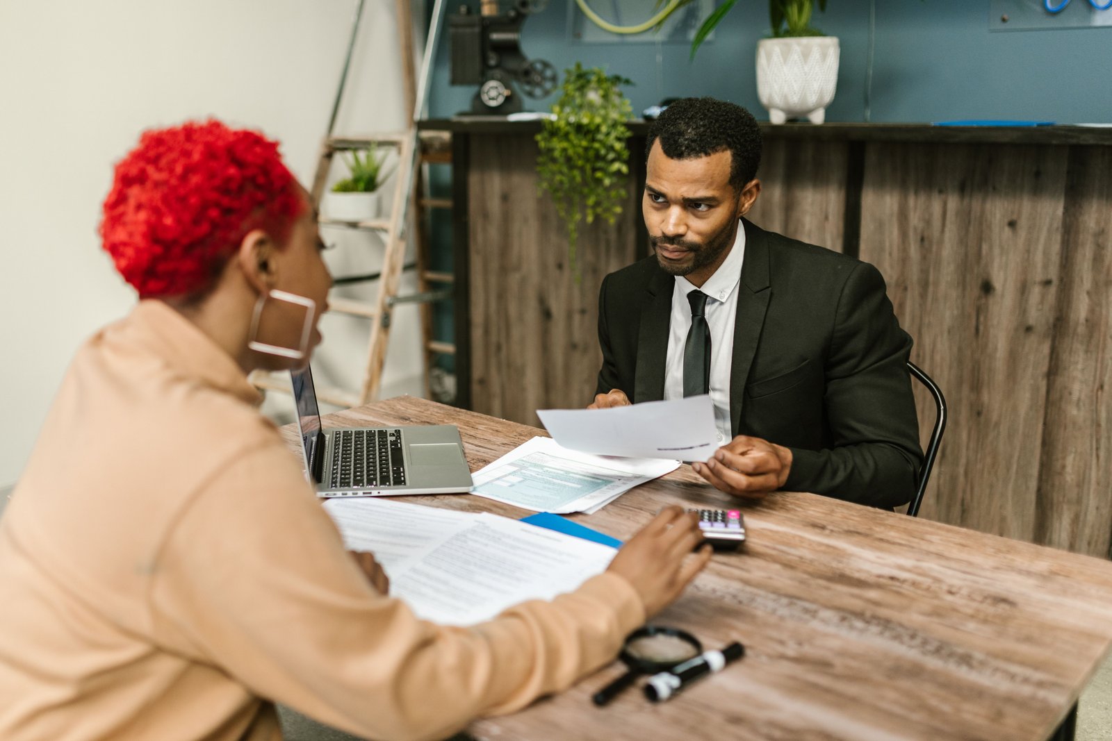Two professionals reviewing financial documents in a modern office, representing the growing professional services firm case study